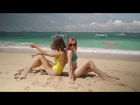 Two women are lying on the sand