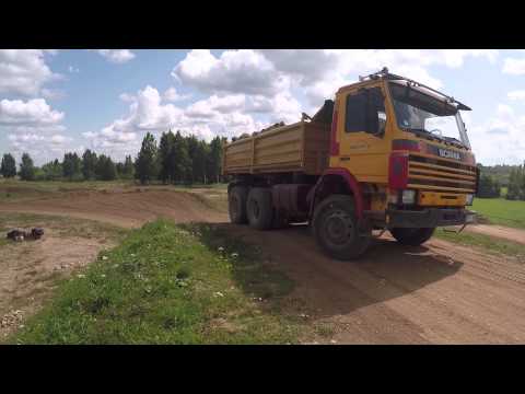 Scania P112  battling steep hill on motocross track