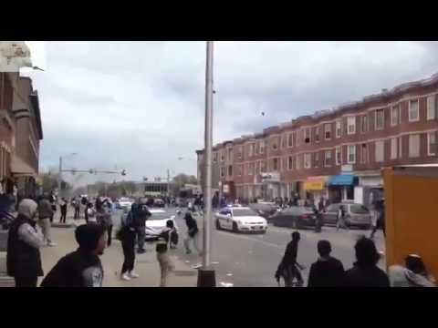 Rioters Throwing Rocks at Passing Police Cars Baltimore
