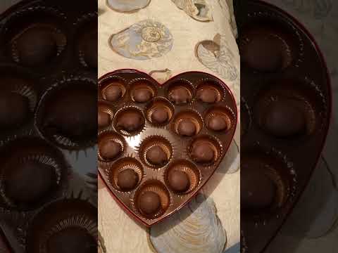 Unboxing a heart shape box of chocolates.