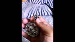 Silver tone spinning rim pendant with 30 inch chain