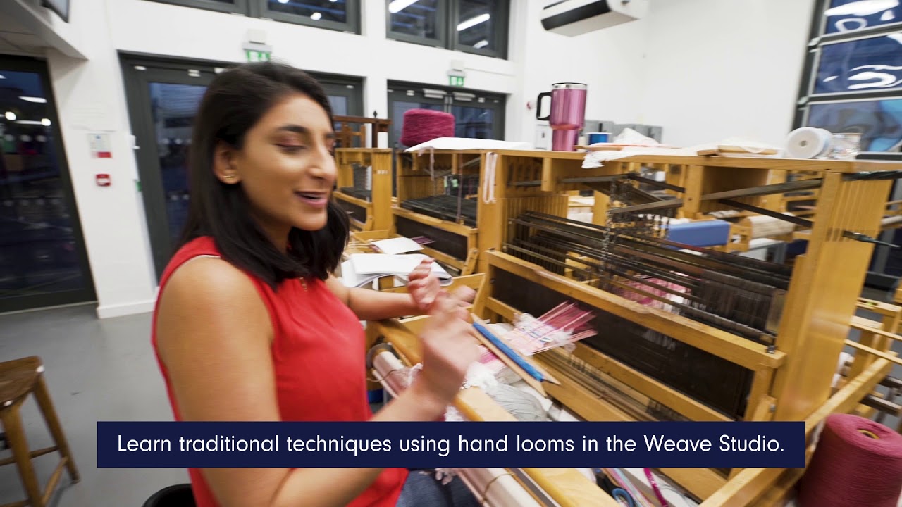 a student using a hand loom in the Weave Studio