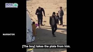 Hamas taking an aid package from a boy after doing a photo-op
