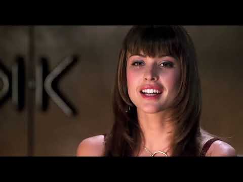 Little Black Book (2004) trailer frame with Brittany Murphy facing a wall of monitors in the talk-show control room