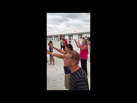 Praying and Singing Hurricane Irma Away on a Florida beach