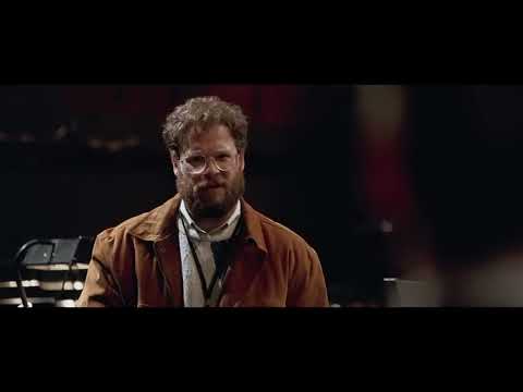 Trailer image: Jobs facing the stage lights before the iMac launch as the score turns digital