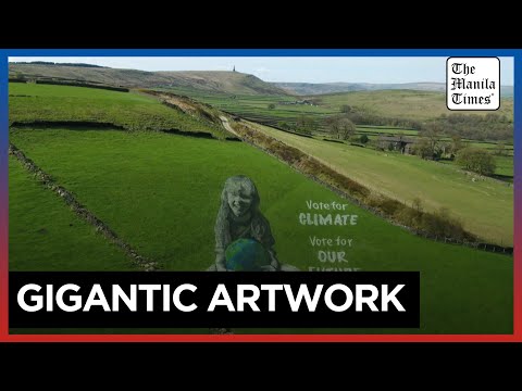 Artists paint UK hillside for Earth Day