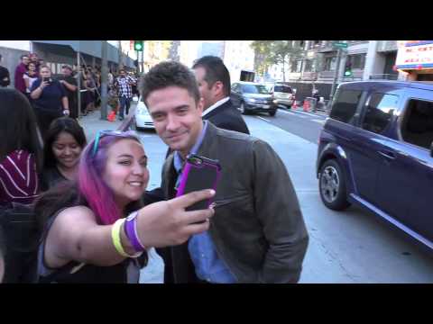 Topher Grace greets fans while arriving at the American Ultra Premiere at Ace Hotel in Los Angeles