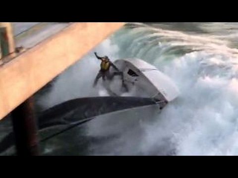 Large wave slams sailboat into pier, crew thrown into water