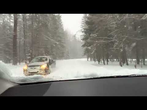 Superb driving through the beautiful snowy Lithuanian road along the forest