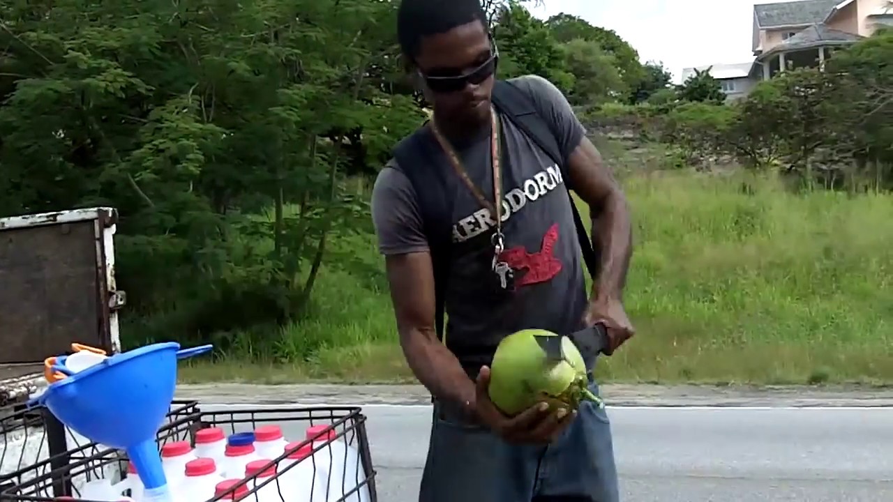 Chopping coconuts with a machete - Buying coconuts in Barbados