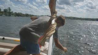 Filling gas on pontoon boat with siphon.