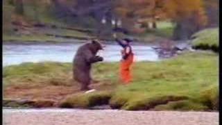 a man  fighting over a fish with bear