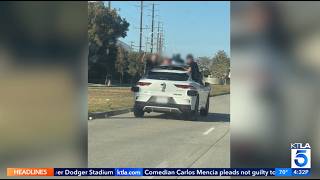 KTLA: Teens Ride On Side Of Waymo Vehicle