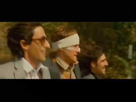 The Darjeeling Limited official trailer thumbnail showing the three Whitman brothers on a train platform