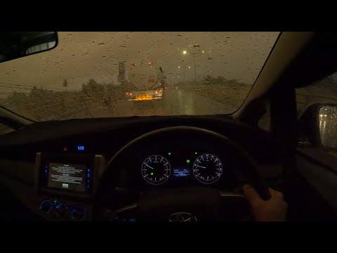 Driving in heavy rain in the city towards evening for sleep, work, study