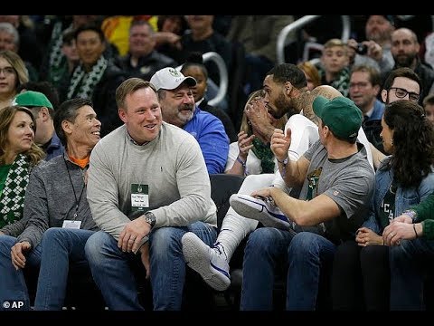 Mike Scott takes a swig from fan's drink after falling into crowd