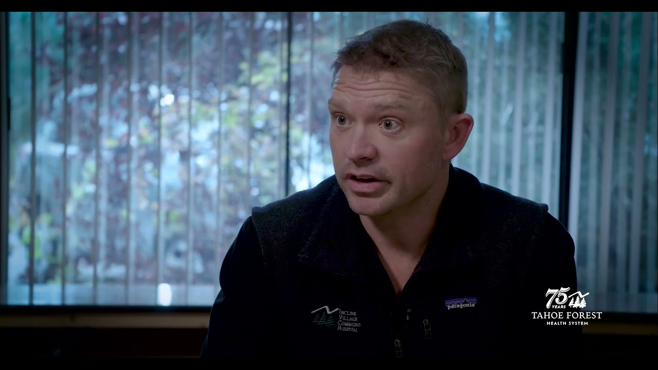 Dr. Michael Jernick, orthopedic surgeon with Tahoe Forest Health System, sitting in front of a window