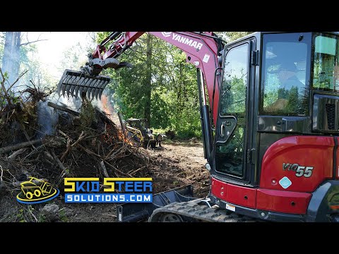 Stacking a burn pile with Digga's Root Rake