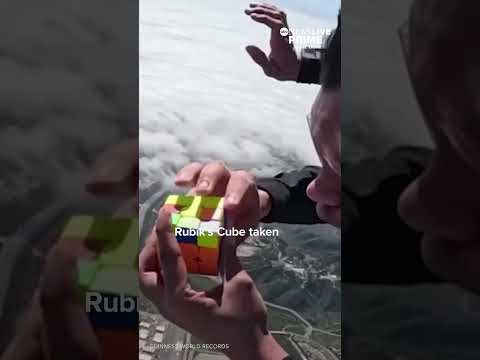 A man sets a world record by solving a Rubik’s Cube while skydiving from 13,000 ft over California.