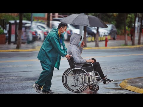 乘坐輪椅的男生雨天獨自出行，有人主動把自己的傘送給他