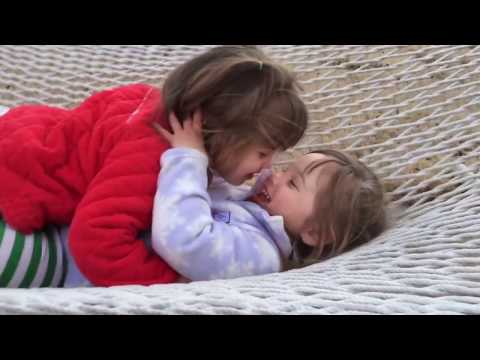 Baby identical twin sisters in the hammock at 2 ½ years old. Lots of cute giggles & kisses.