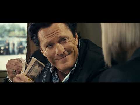 Trailer frame with night streets and cyan-magenta grade matching the album’s retro-meets-industrial palette