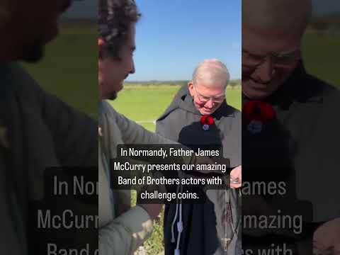 In Normandy, Father James McCurry presents our amazing Band of Brothers actors with challenge coins.