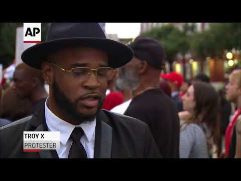 Protesters gathered at police headquarters in Dallas to speak out against the shooting death of a black man by a white officer who says she mistook his apartment for hers. (Sept. 11)