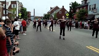 The Alumni Band, Alumni Twirlers and Maine Attraction march in La Kermesse Parade.