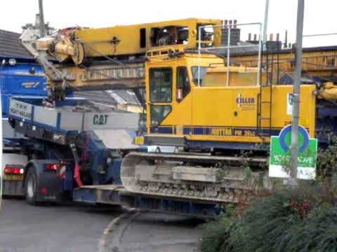 Scania Topline & low loader reversing a junttan piling machine into our compound