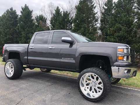 Lifted 2014 Chevrolet 1500 24x14 american forces lift on a 7" Mcgaughy's kit