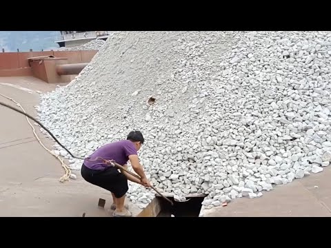 Barge unloading white limestone, natural sound of rock flow
