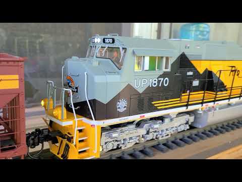 Twin SD70ACEs in g scale pulling 35 hopper cars