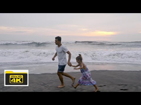 A Father Running with his Daughter on the Beach sand 4k Video