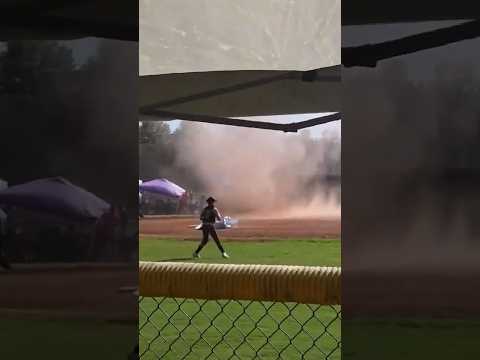 Dust devil swirls through an Alabama softball game