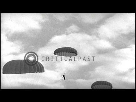 Soldiers jump out of the airplane and descend on the land with the help of parach...HD Stock Footage