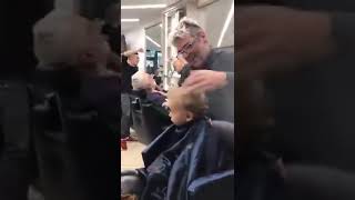 Guys in a barbershop in italy sing to a little boy tp ease his first time shaving his head