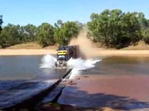 Road Train going flat out over a river crossing   Western Australia