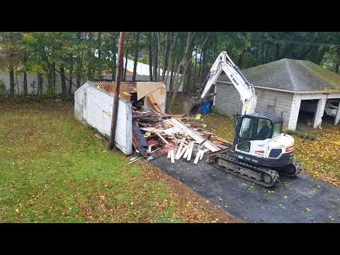 Excavator destroying the garage