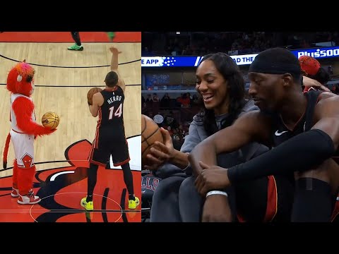 Bam Adebayo with A'ja Wilson and Tyler Herro vs Bulls mascot during game delay