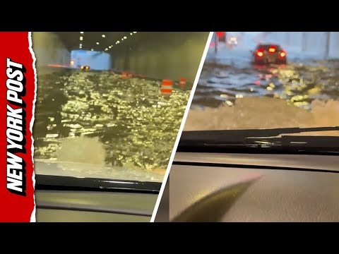 Frightened motorist prays for safety as she drives through flooded tunnel