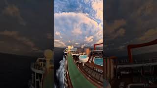 Walking along the top deck of Celebrity Apex and the sun sets over the open ocean