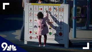 Communication board set up at playground to help nonverbal kids communicate, make friends