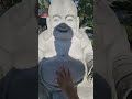 rubbing tummy of the buddha for good luck