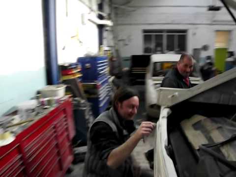 Fuzz Townshend in his workshop, with the Practical Classics MGB and others