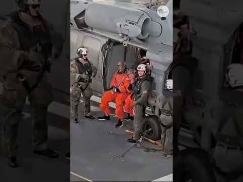 Astronauts wave following a successful return to Earth