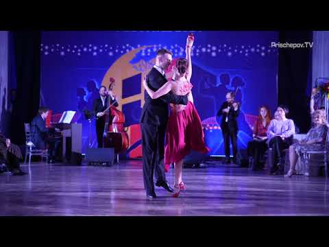  Dmitriy Rizhov  and  Viktoria Krivcova  are  dancing  to  the  tango  "  Loca  "  by  Solo Tango Orquesta  at  La Boca Tango Festival  in  2021