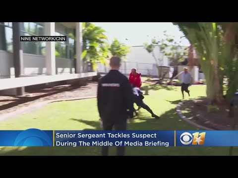 Senior Sergeant Tackles Suspect During Media Briefing