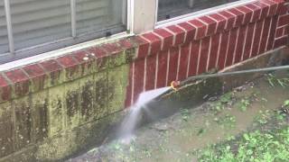 Pressure washing brick house